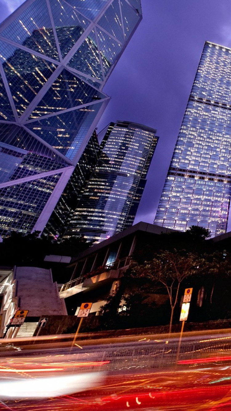 Cars on Road Near High Rise Buildings During Night Time. Wallpaper in 750x1334 Resolution