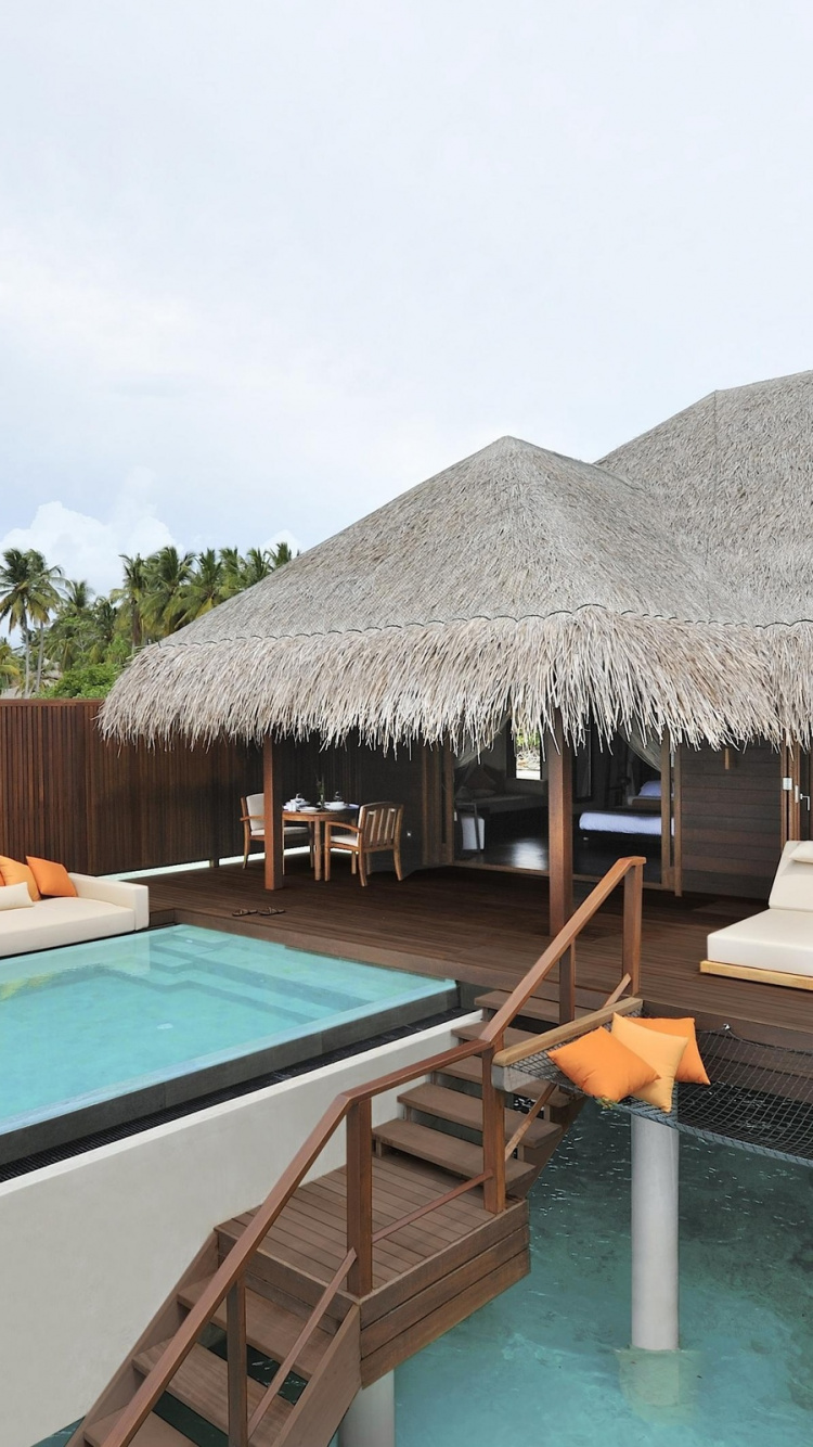 Brown Wooden Beach House Near Swimming Pool Under Blue Sky During Daytime. Wallpaper in 750x1334 Resolution