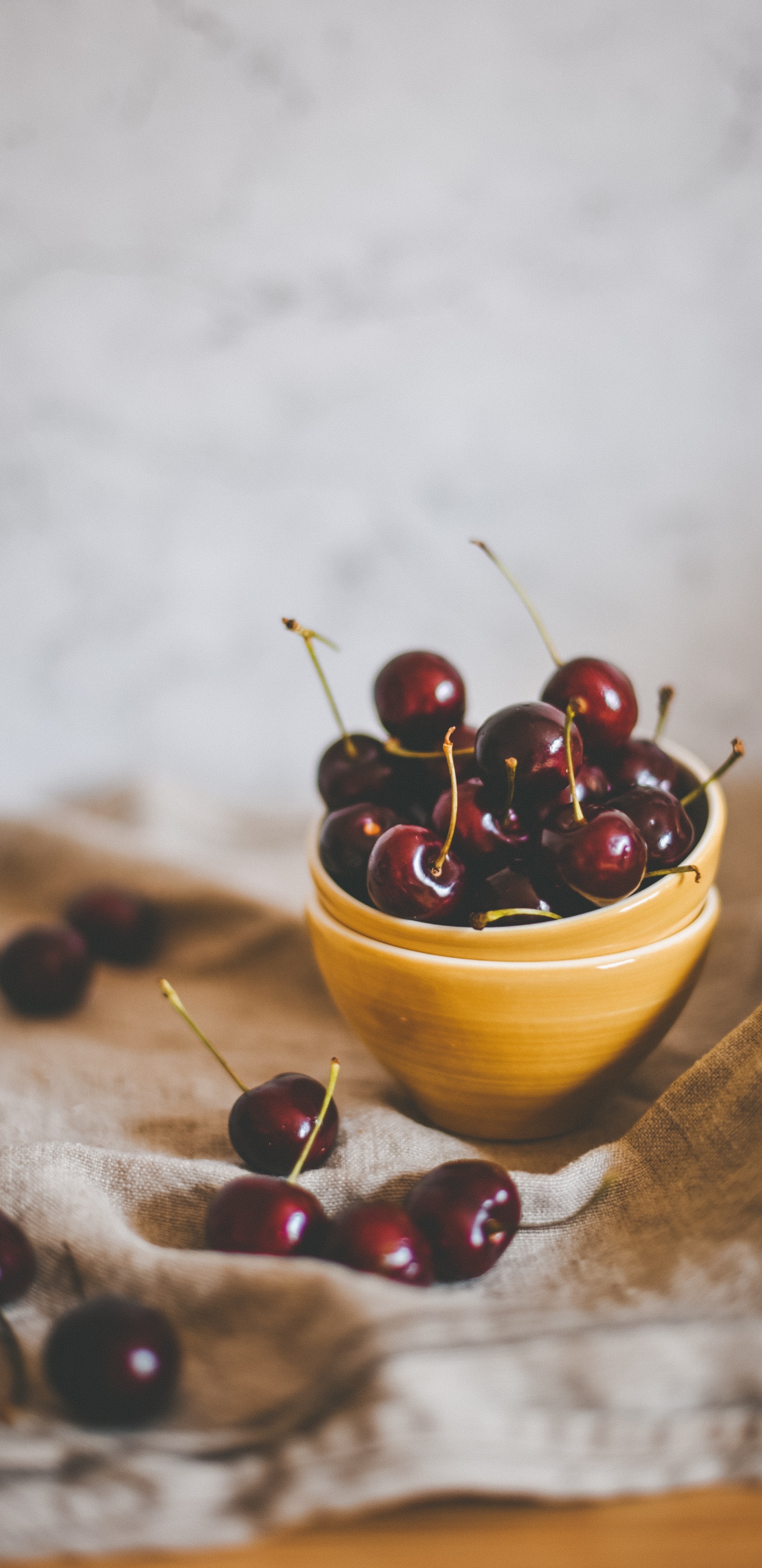 Red Round Fruits on Brown Wooden Bowl. Wallpaper in 1440x2960 Resolution