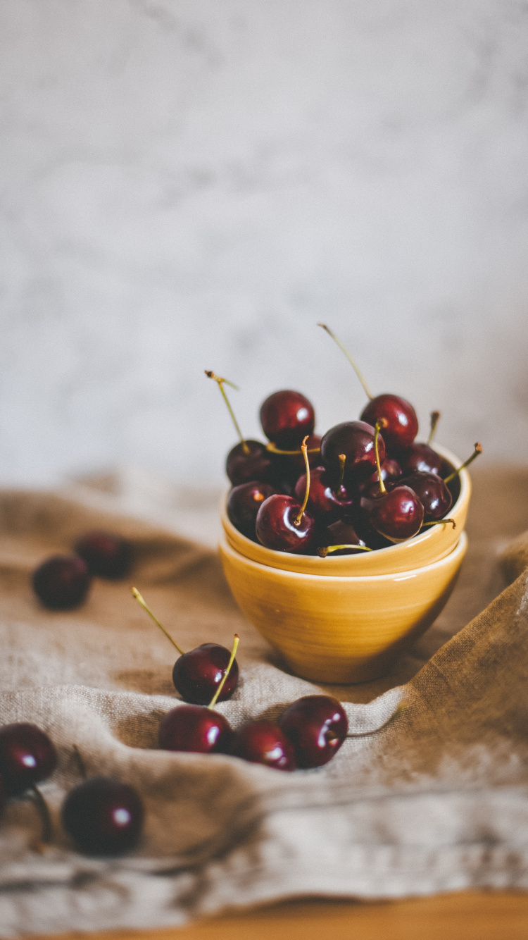 Red Round Fruits on Brown Wooden Bowl. Wallpaper in 750x1334 Resolution