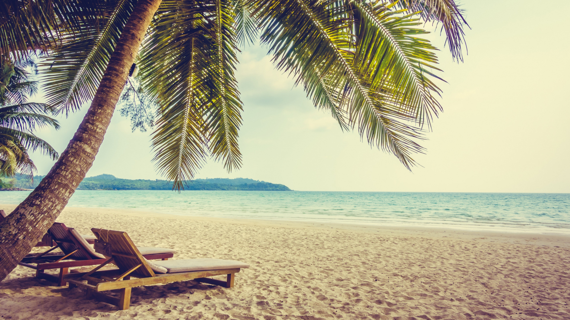 Brown Wooden Lounge Chair on Beach During Daytime. Wallpaper in 1920x1080 Resolution