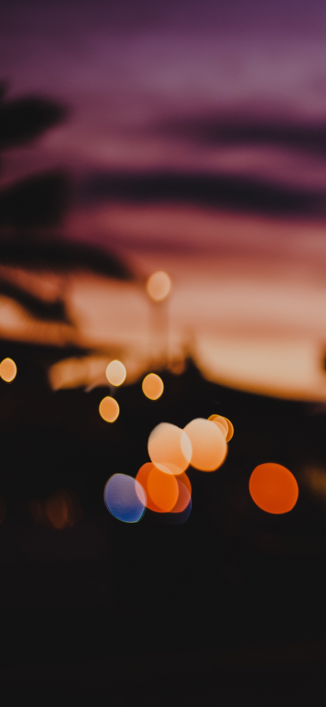 Bokeh Photography of Orange Lights. Wallpaper in 1125x2436 Resolution