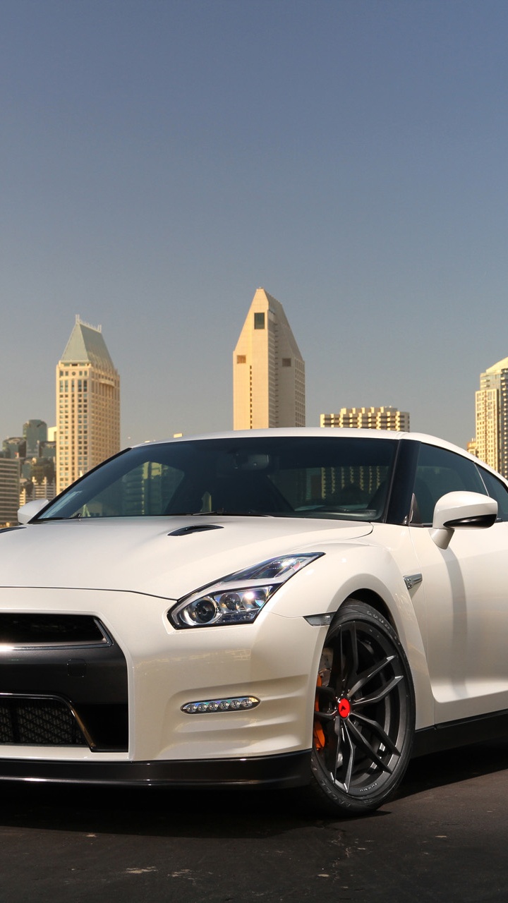 White Porsche 911 Parked on Gray Concrete Pavement Near City Buildings During Daytime. Wallpaper in 720x1280 Resolution