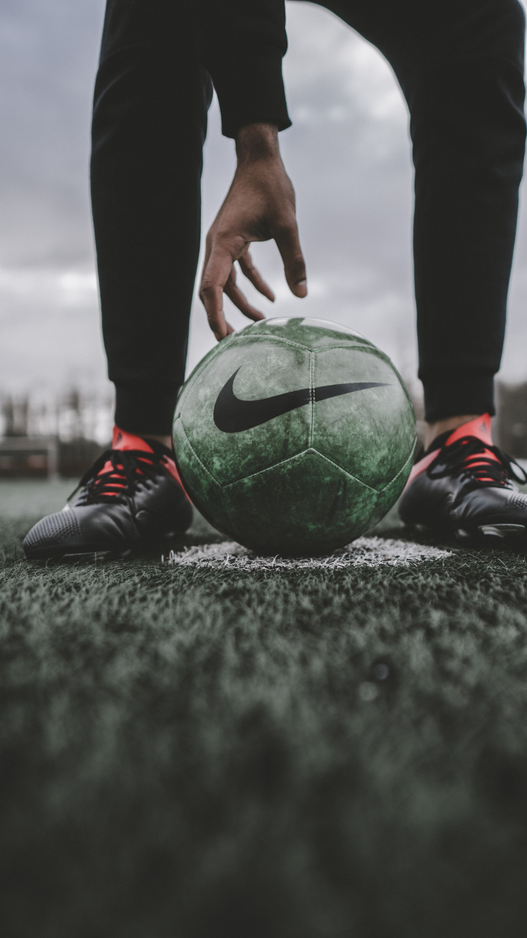 Person in Black Pants and Red and White Soccer Ball. Wallpaper in 750x1334 Resolution