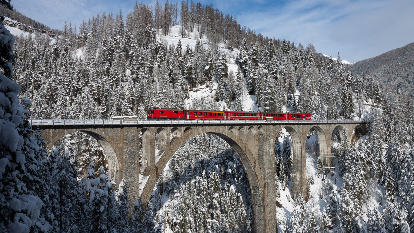 Roter Zug Auf Eisenbahnbrücke in Der Nähe Von Bäumen, Die Tagsüber Mit Schnee Bedeckt Sind?. Wallpaper in 1366x768 Resolution