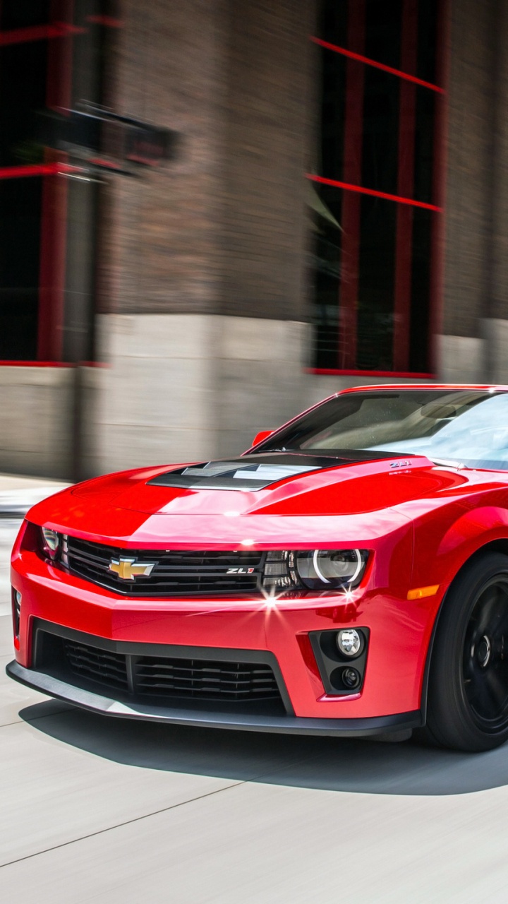 Red Chevrolet Camaro Parked in Front of Brown Building. Wallpaper in 720x1280 Resolution