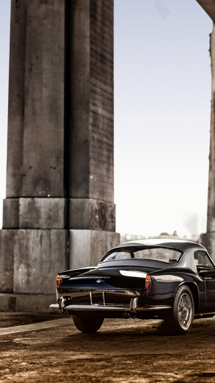 Black Coupe Parked Near Concrete Building During Daytime. Wallpaper in 750x1334 Resolution