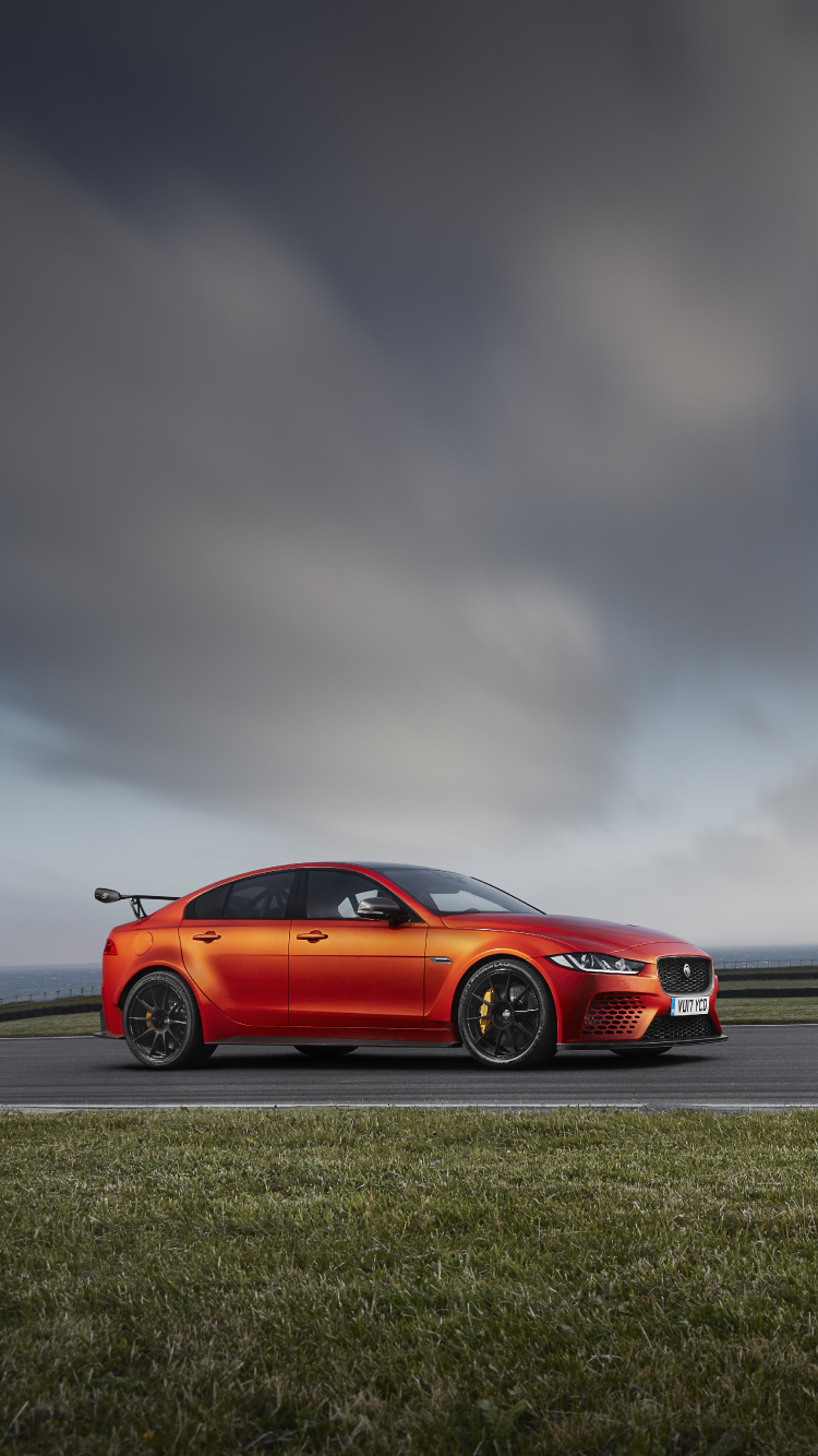 Red Coupe on Gray Asphalt Road Under Gray Cloudy Sky. Wallpaper in 750x1334 Resolution