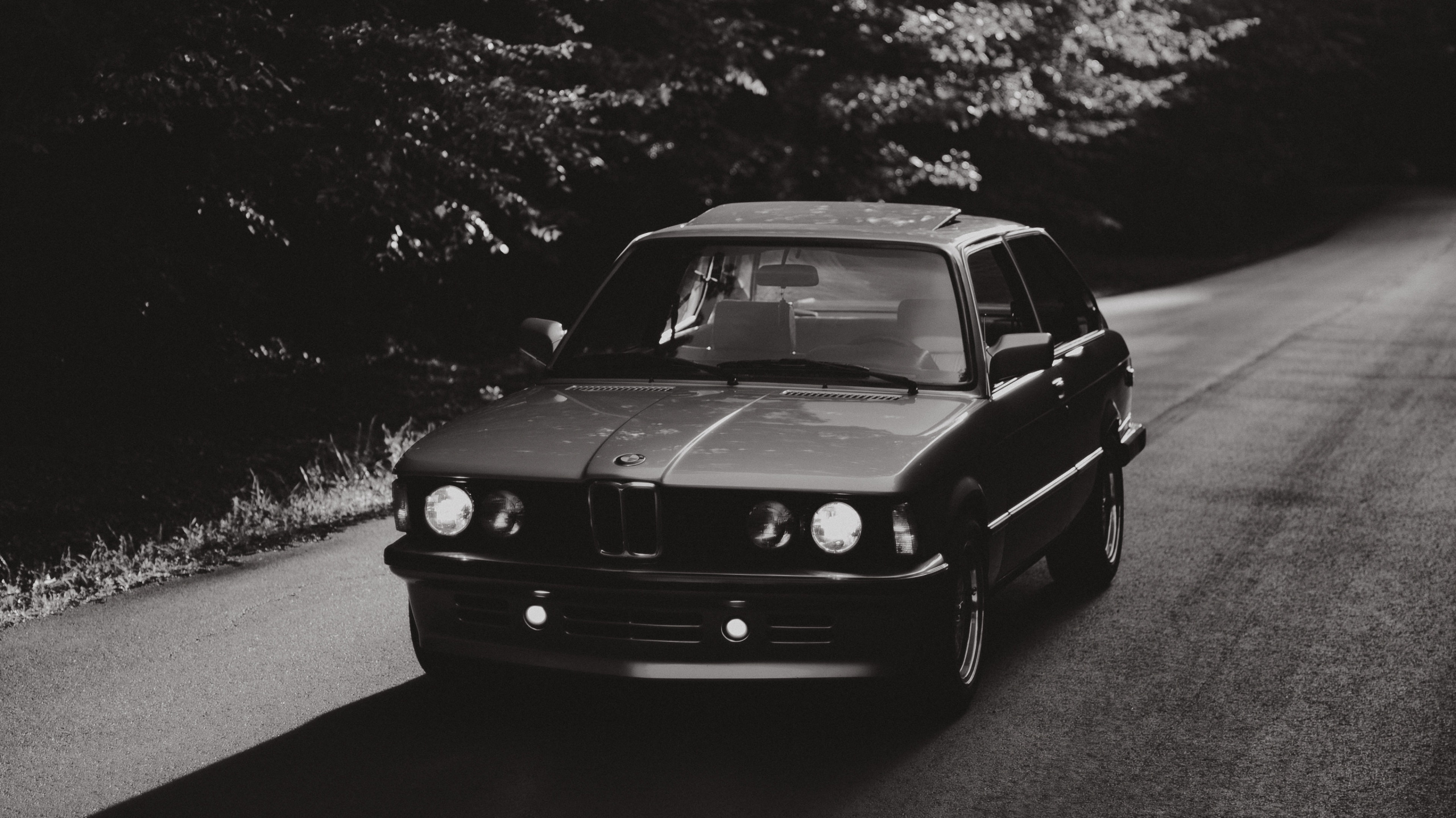 Black Car on Road in Grayscale Photography. Wallpaper in 2560x1440 Resolution
