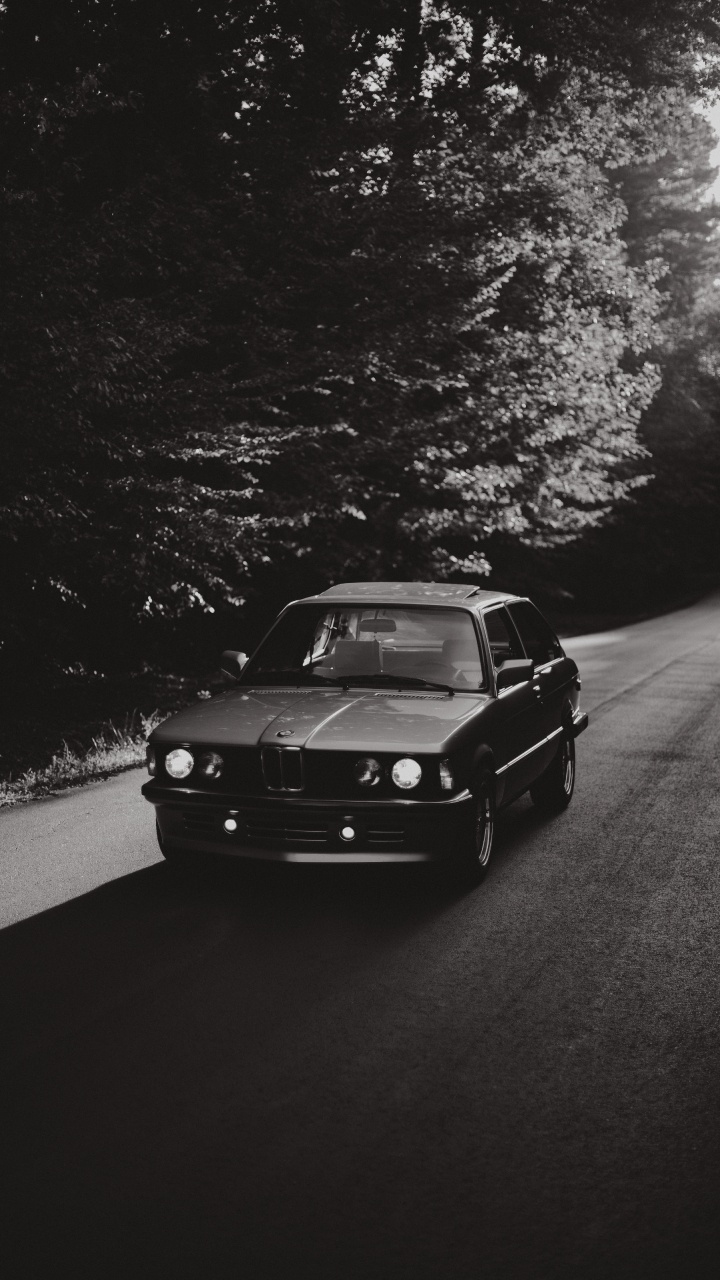 Black Car on Road in Grayscale Photography. Wallpaper in 720x1280 Resolution