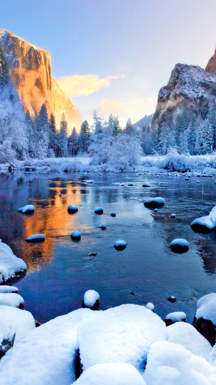 Brown Rocky Mountain Near Body of Water During Daytime. Wallpaper in 750x1334 Resolution