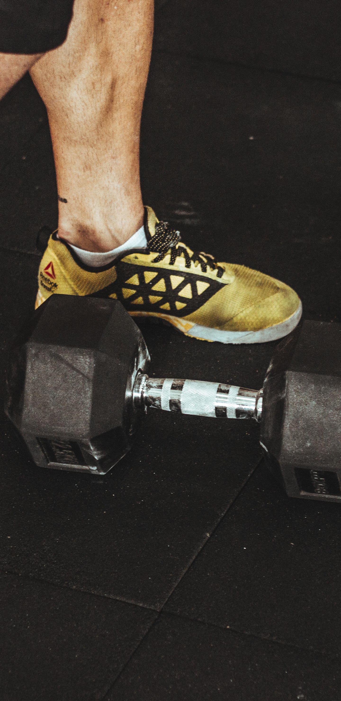 Person Wearing Yellow and Black Nike Athletic Shoes. Wallpaper in 1440x2960 Resolution