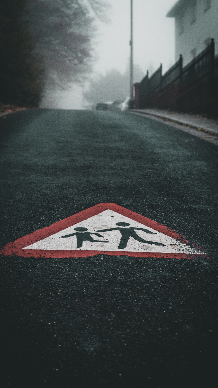 Black White and Red Arrow Sign on Road. Wallpaper in 750x1334 Resolution