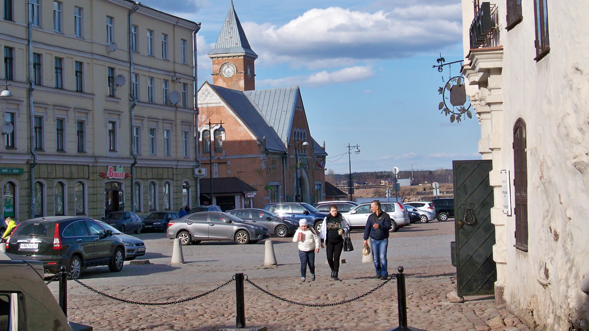 Cars Parked on Parking Lot Near Brown Concrete Building During Daytime. Wallpaper in 1920x1080 Resolution
