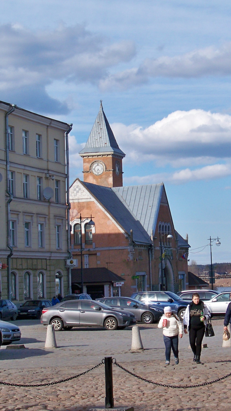Voitures Garées Sur un Parking Près D'un Bâtiment en Béton Brun Pendant la Journée. Wallpaper in 750x1334 Resolution