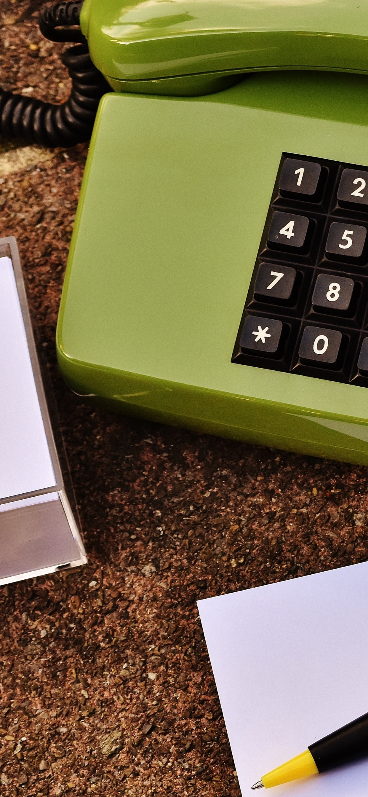 White Printer Paper Beside Green Telephone. Wallpaper in 1242x2688 Resolution