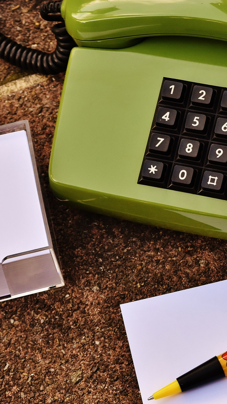 White Printer Paper Beside Green Telephone. Wallpaper in 750x1334 Resolution
