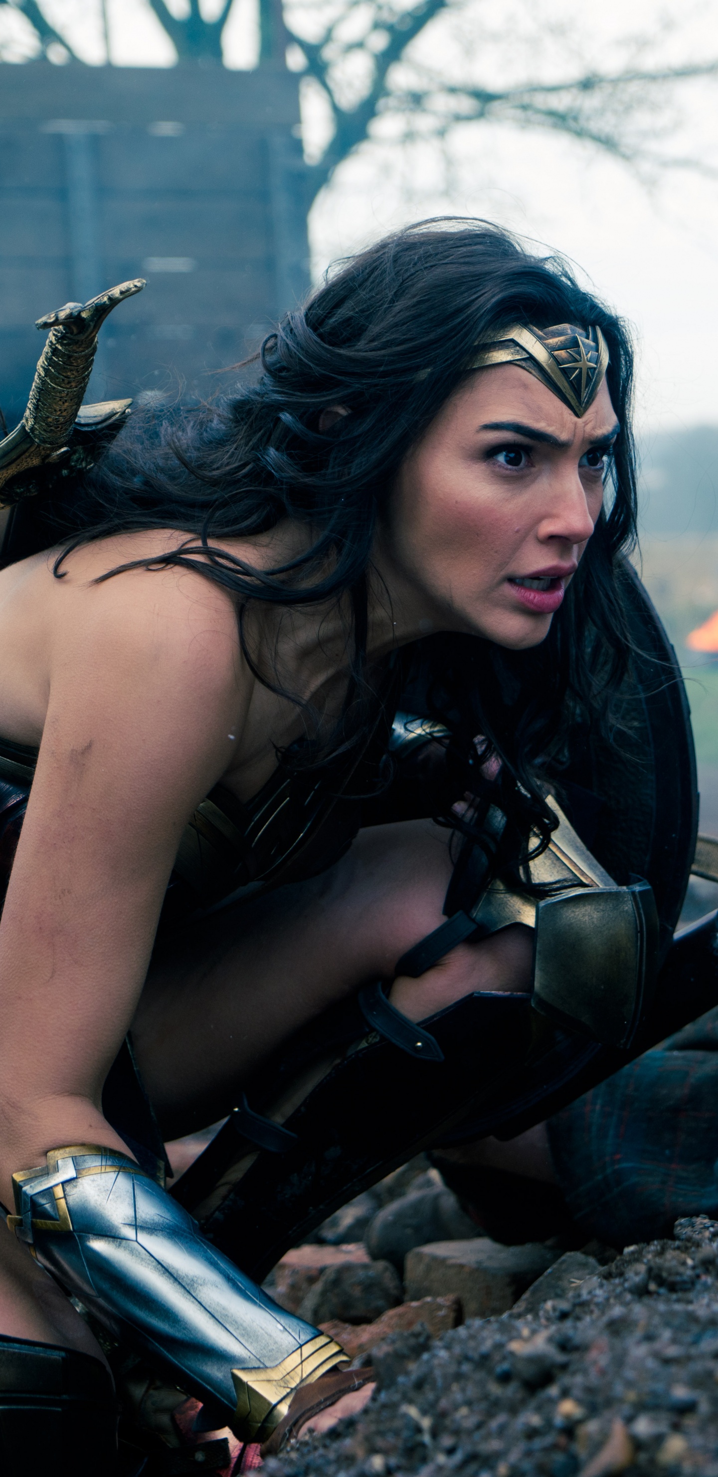 Woman in Black Tank Top Sitting on Black and Brown Rock During Daytime. Wallpaper in 1440x2960 Resolution