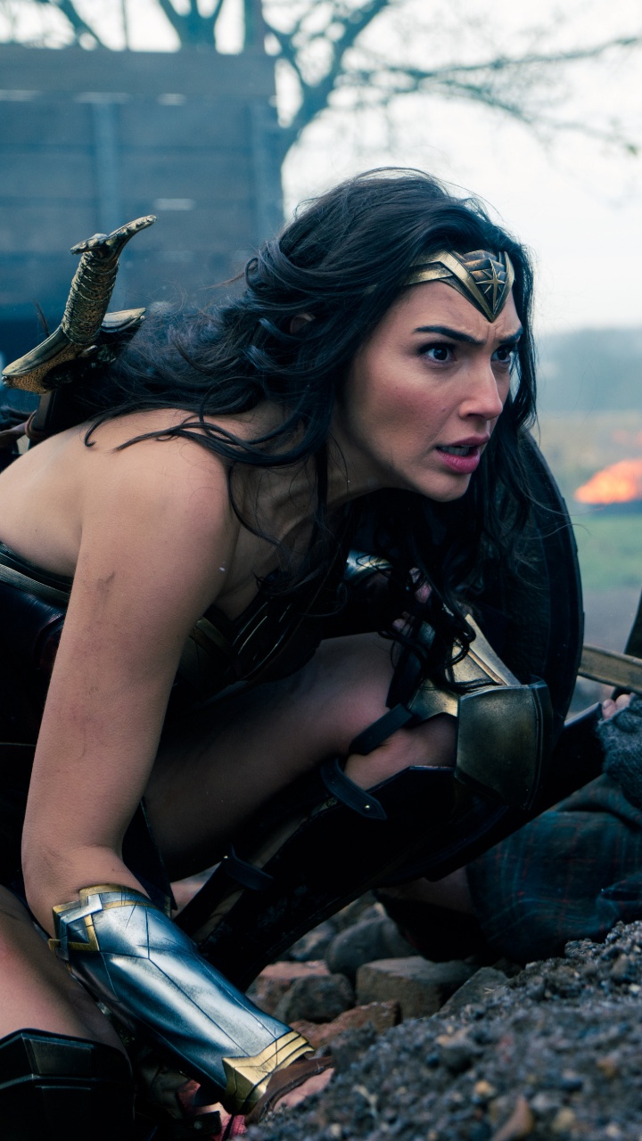 Woman in Black Tank Top Sitting on Black and Brown Rock During Daytime. Wallpaper in 720x1280 Resolution