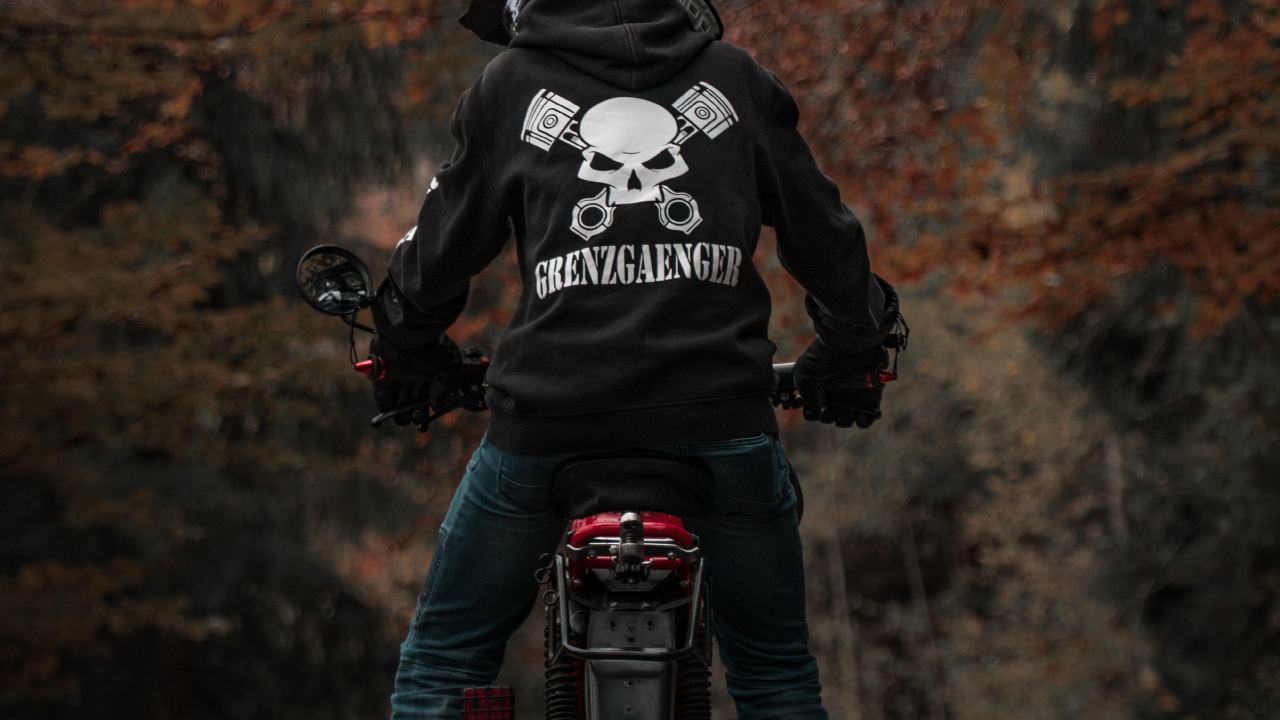 Man in Black and White Jacket Riding Motorcycle. Wallpaper in 1280x720 Resolution