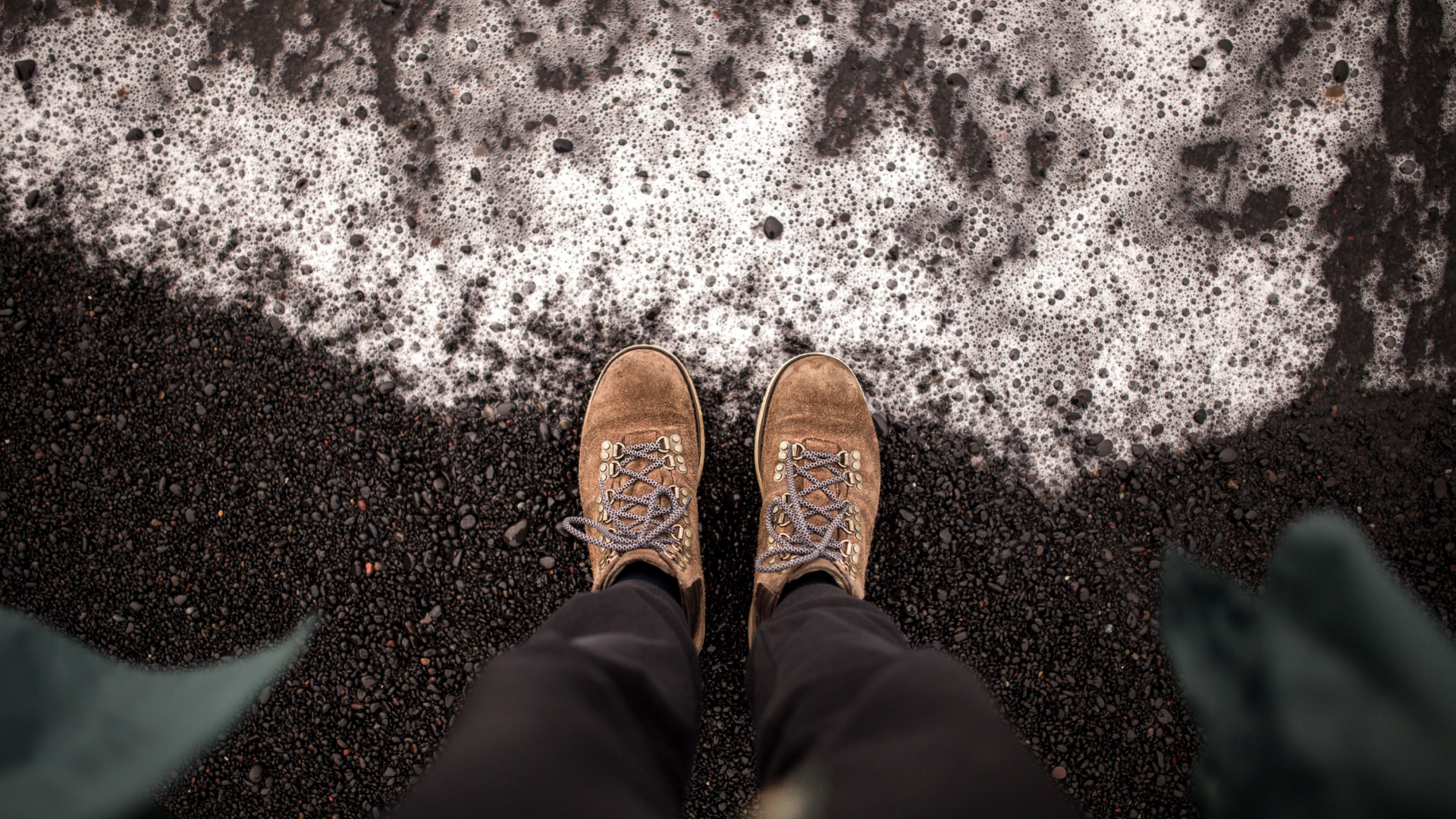 Person in Black Pants and Brown Shoes Standing on Snow Covered Ground. Wallpaper in 1920x1080 Resolution
