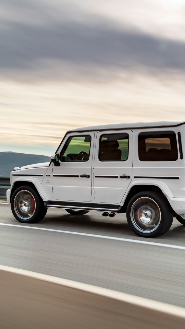 White Suv on Gray Asphalt Road During Daytime. Wallpaper in 720x1280 Resolution