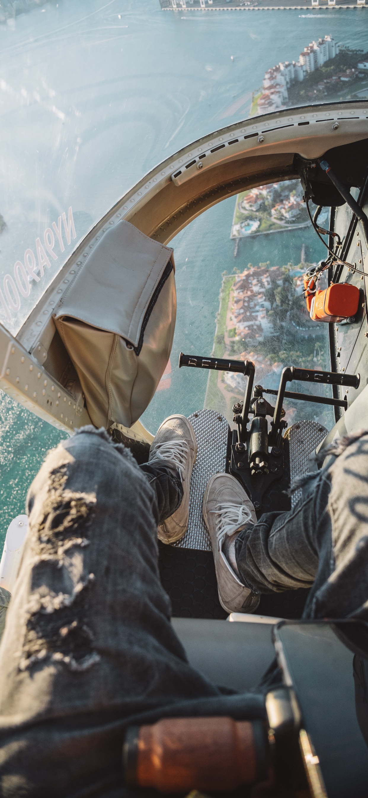 Person in Gray Denim Jeans Lying on Boat During Daytime. Wallpaper in 1242x2688 Resolution