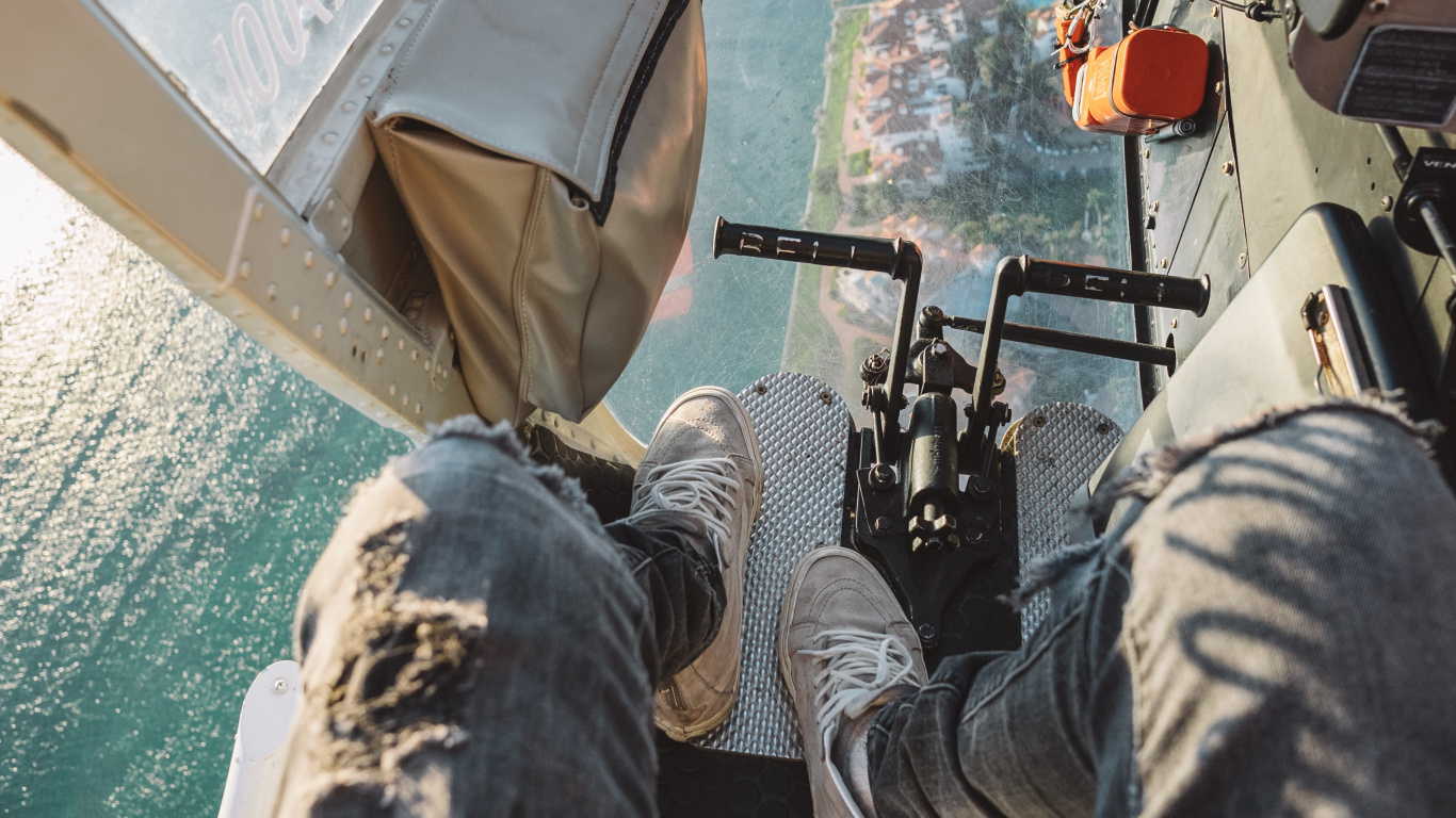 Person in Gray Denim Jeans Lying on Boat During Daytime. Wallpaper in 1366x768 Resolution