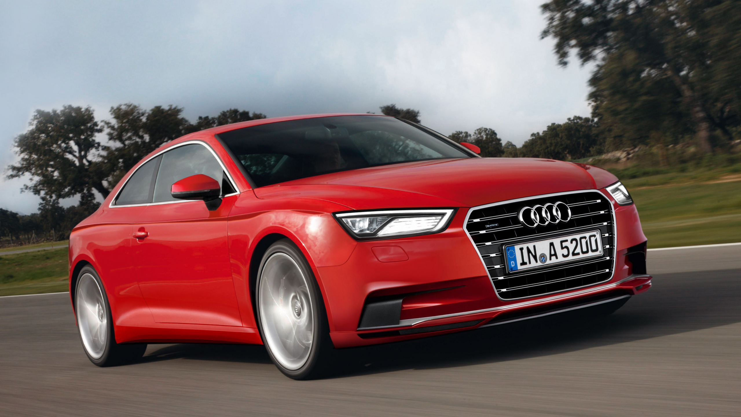 Red Audi Coupe on Road. Wallpaper in 2560x1440 Resolution