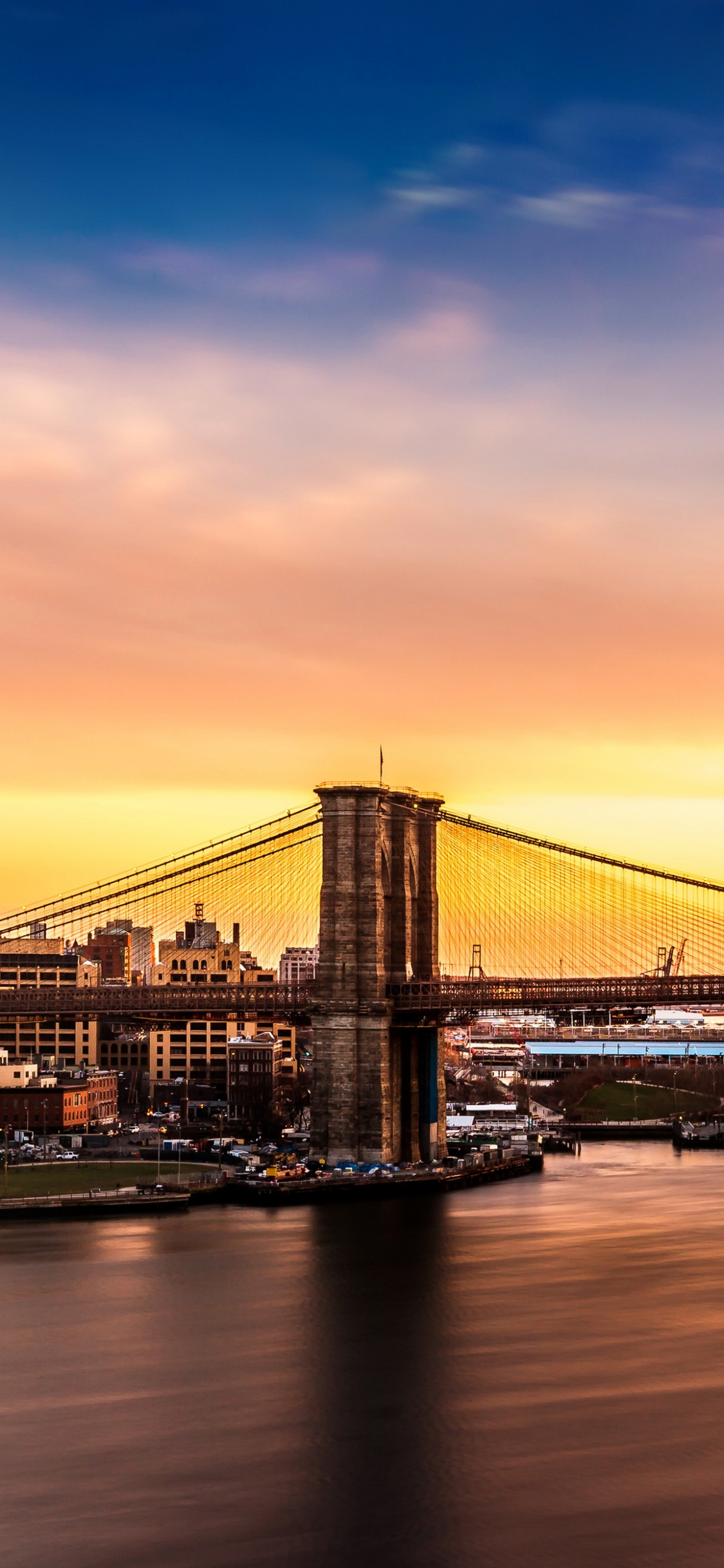 Bridge Over Water During Sunset. Wallpaper in 1125x2436 Resolution