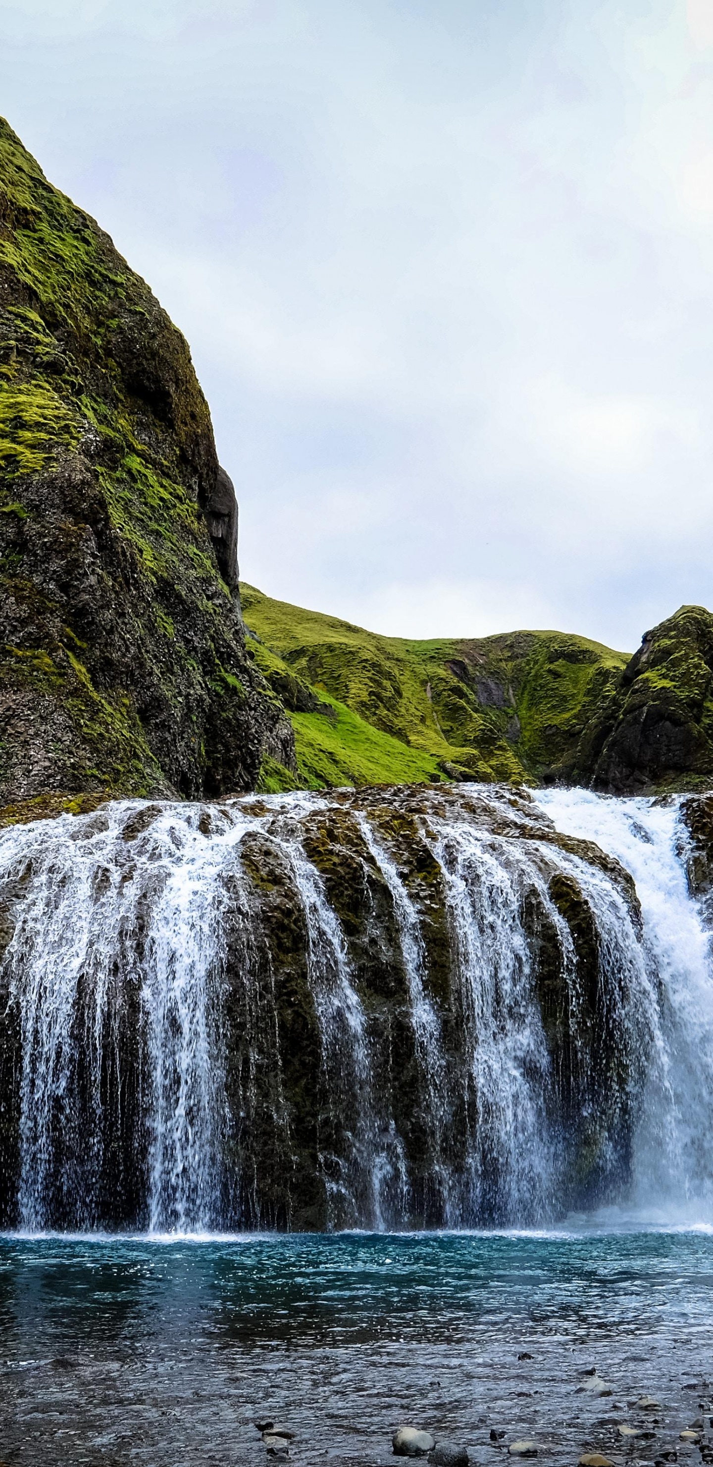 Waterfalls on Green Mountain Under White Sky During Daytime. Wallpaper in 1440x2960 Resolution