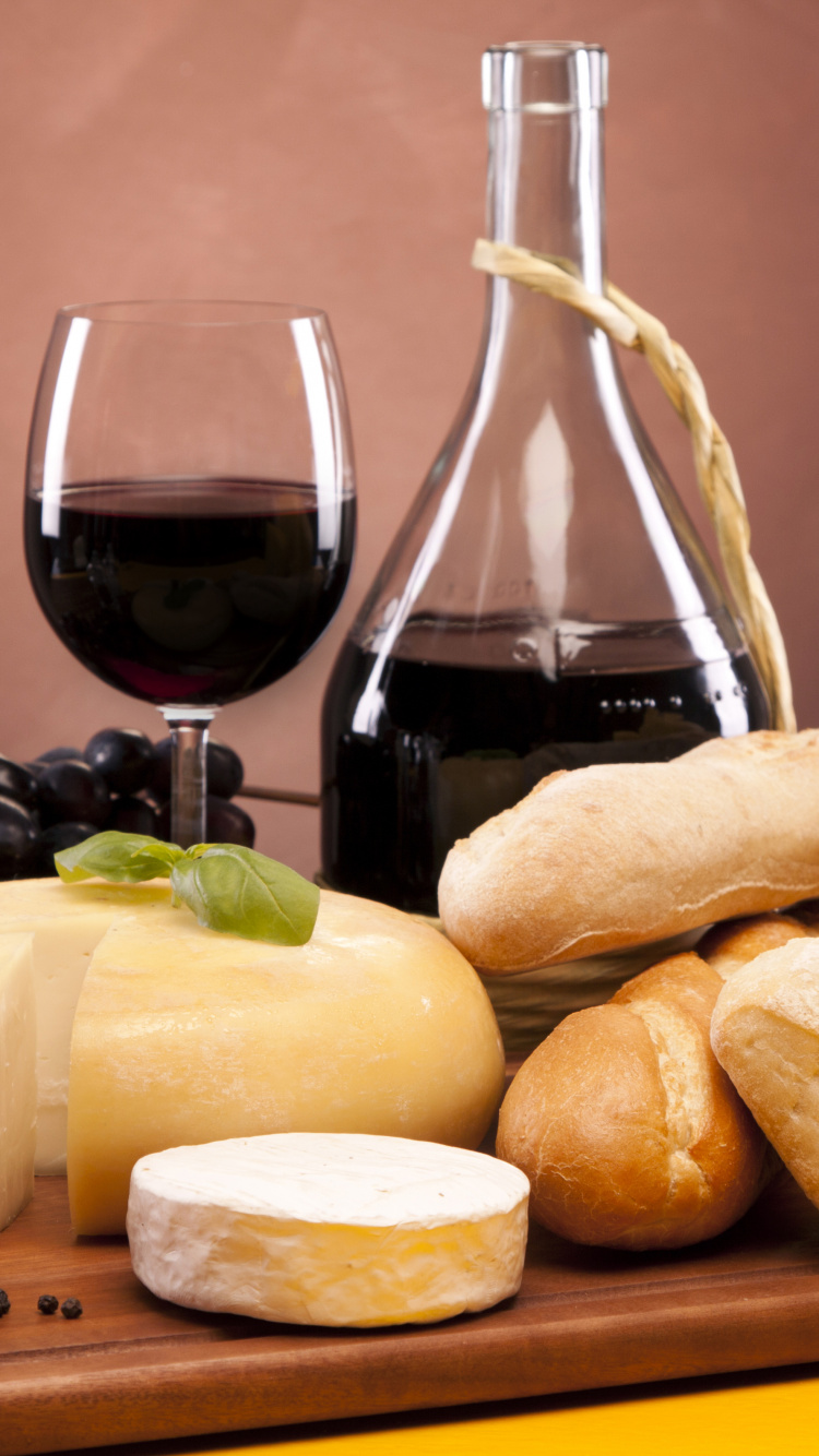 Clear Glass Bottle Beside Bread. Wallpaper in 750x1334 Resolution