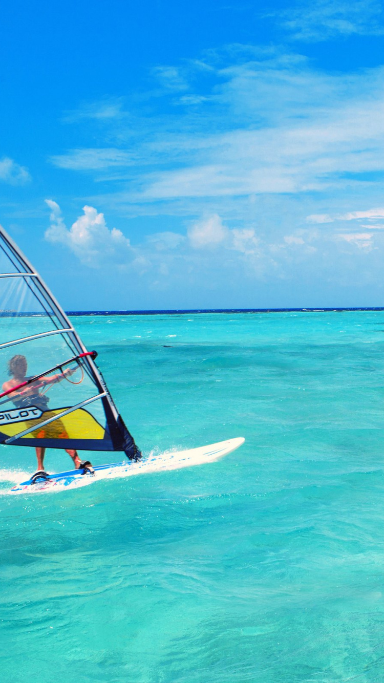 White and Yellow Sail Boat on Sea Under Blue Sky During Daytime. Wallpaper in 750x1334 Resolution