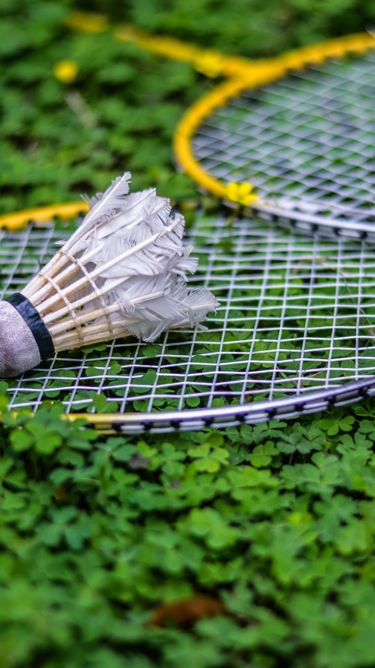 White and Black Tennis Racket on Green Grass. Wallpaper in 750x1334 Resolution