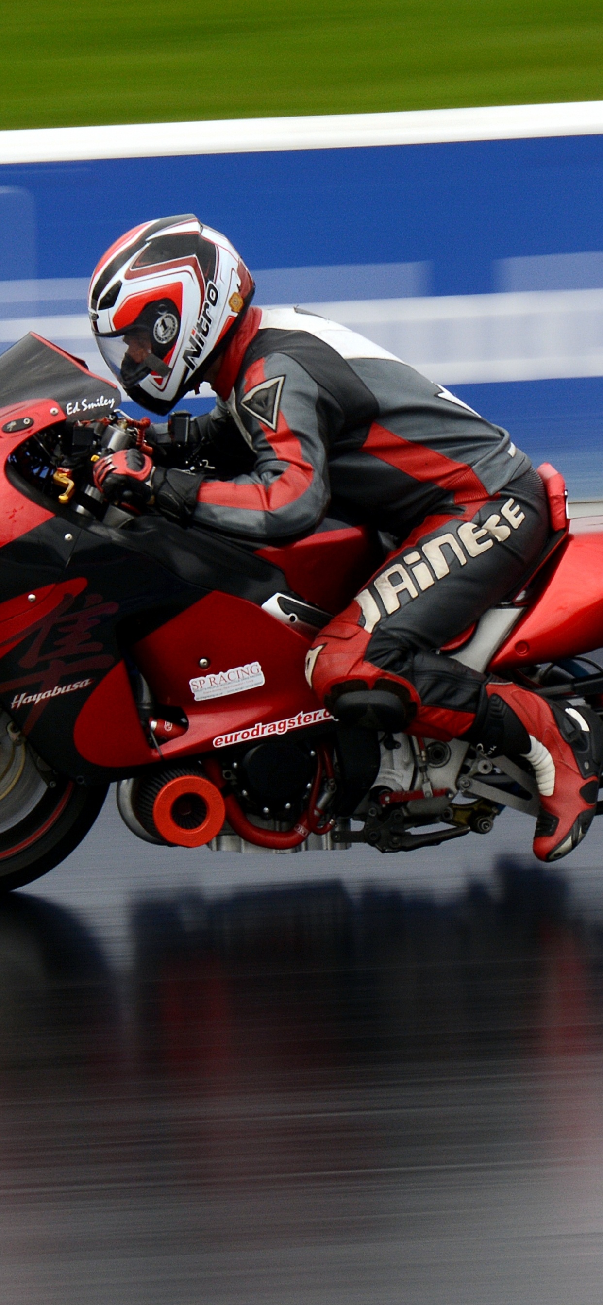 Man in Red and Black Motorcycle Helmet Riding Red Sports Bike. Wallpaper in 1242x2688 Resolution