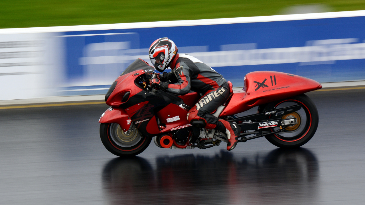 Man in Red and Black Motorcycle Helmet Riding Red Sports Bike. Wallpaper in 1280x720 Resolution