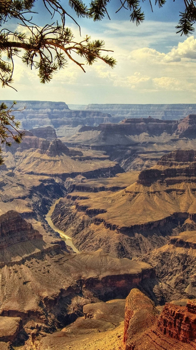 Brown Rocky Mountain Under Blue Sky During Daytime. Wallpaper in 750x1334 Resolution