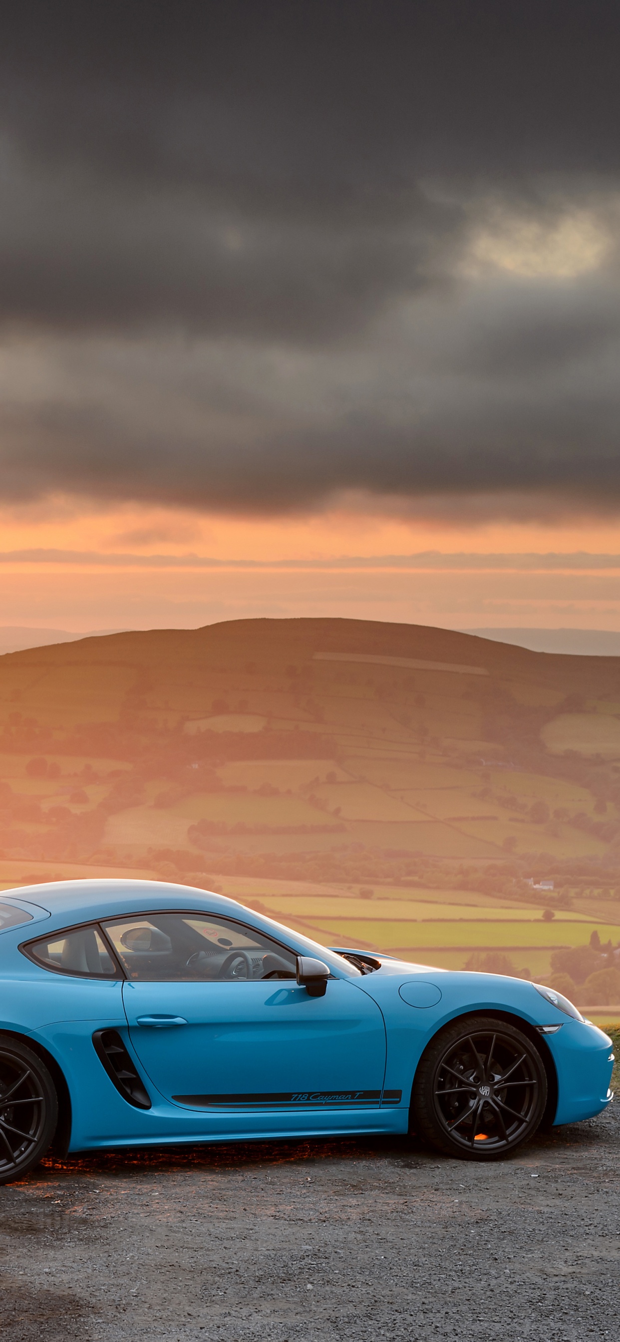 Blue Porsche 911 on Desert During Sunset. Wallpaper in 1242x2688 Resolution
