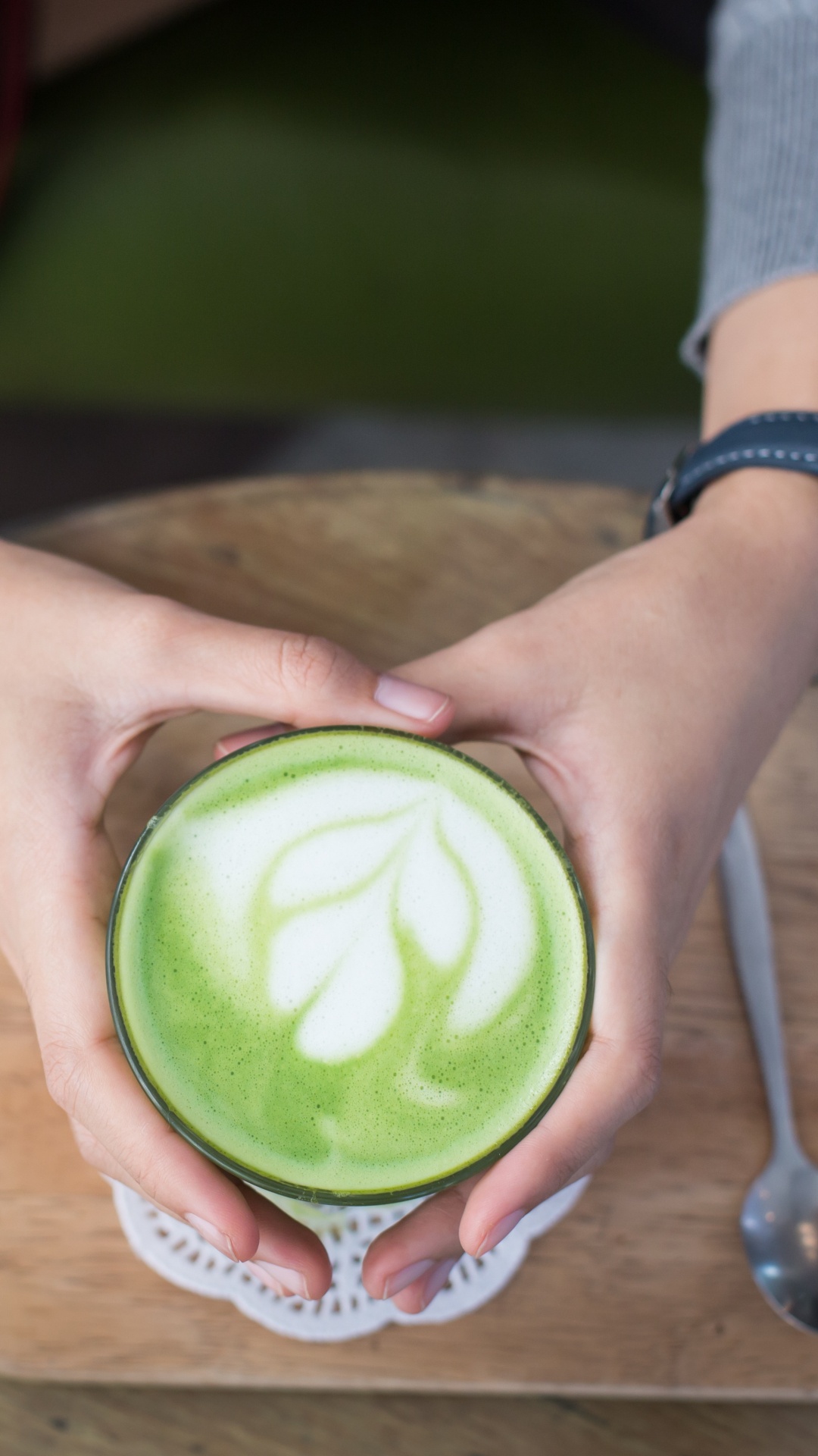 Person Holding Green and White Plastic Cup. Wallpaper in 1080x1920 Resolution