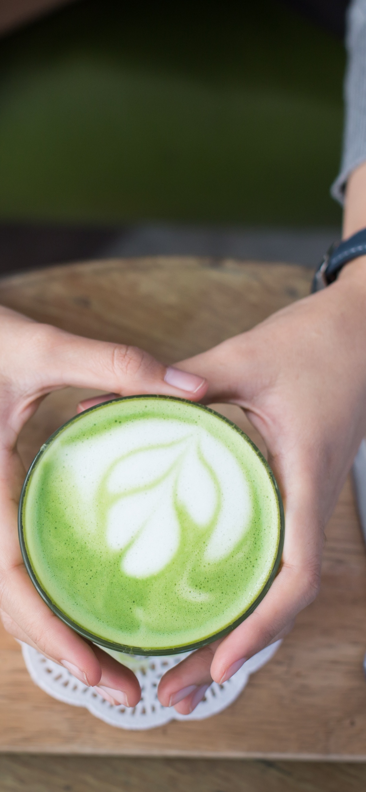 Person Holding Green and White Plastic Cup. Wallpaper in 1242x2688 Resolution