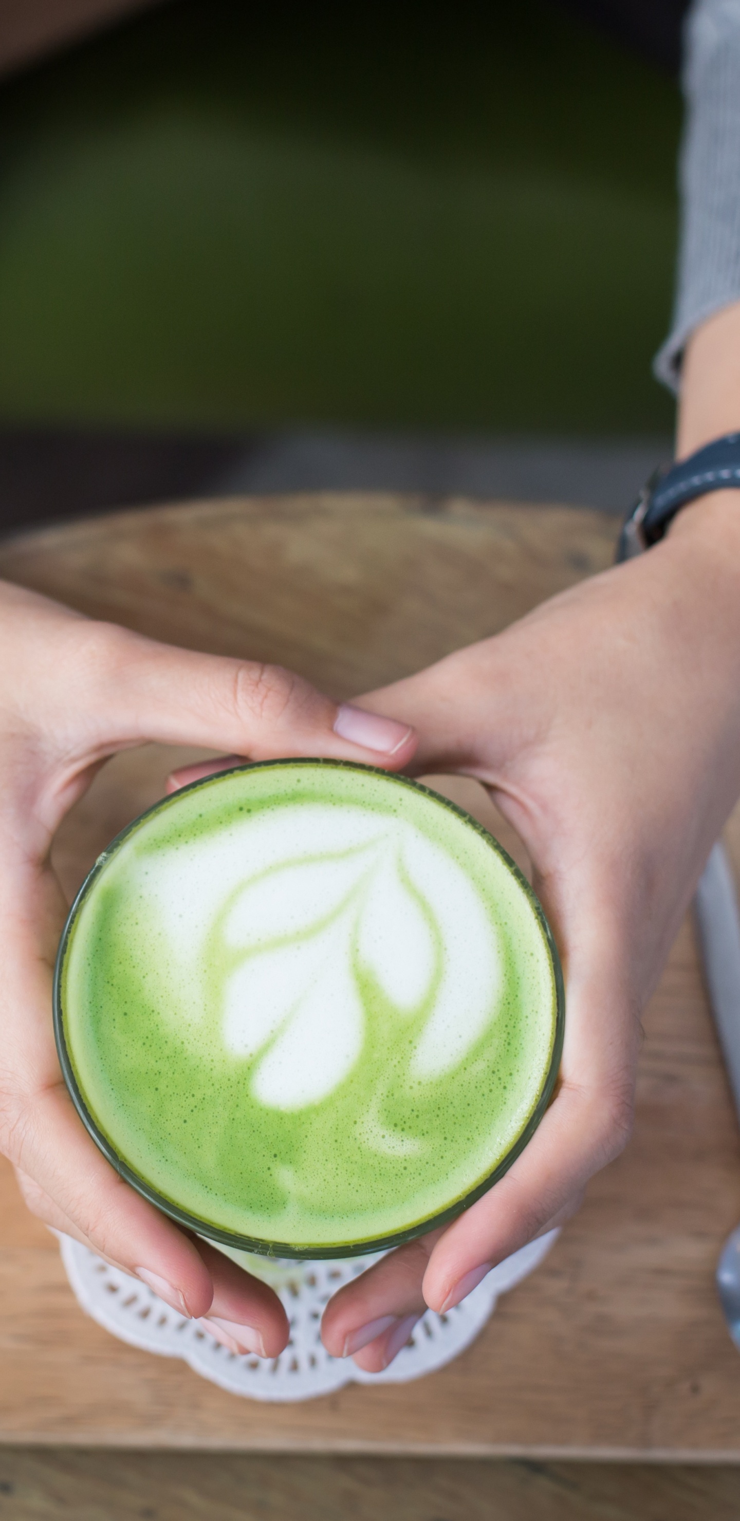 Person Holding Green and White Plastic Cup. Wallpaper in 1440x2960 Resolution