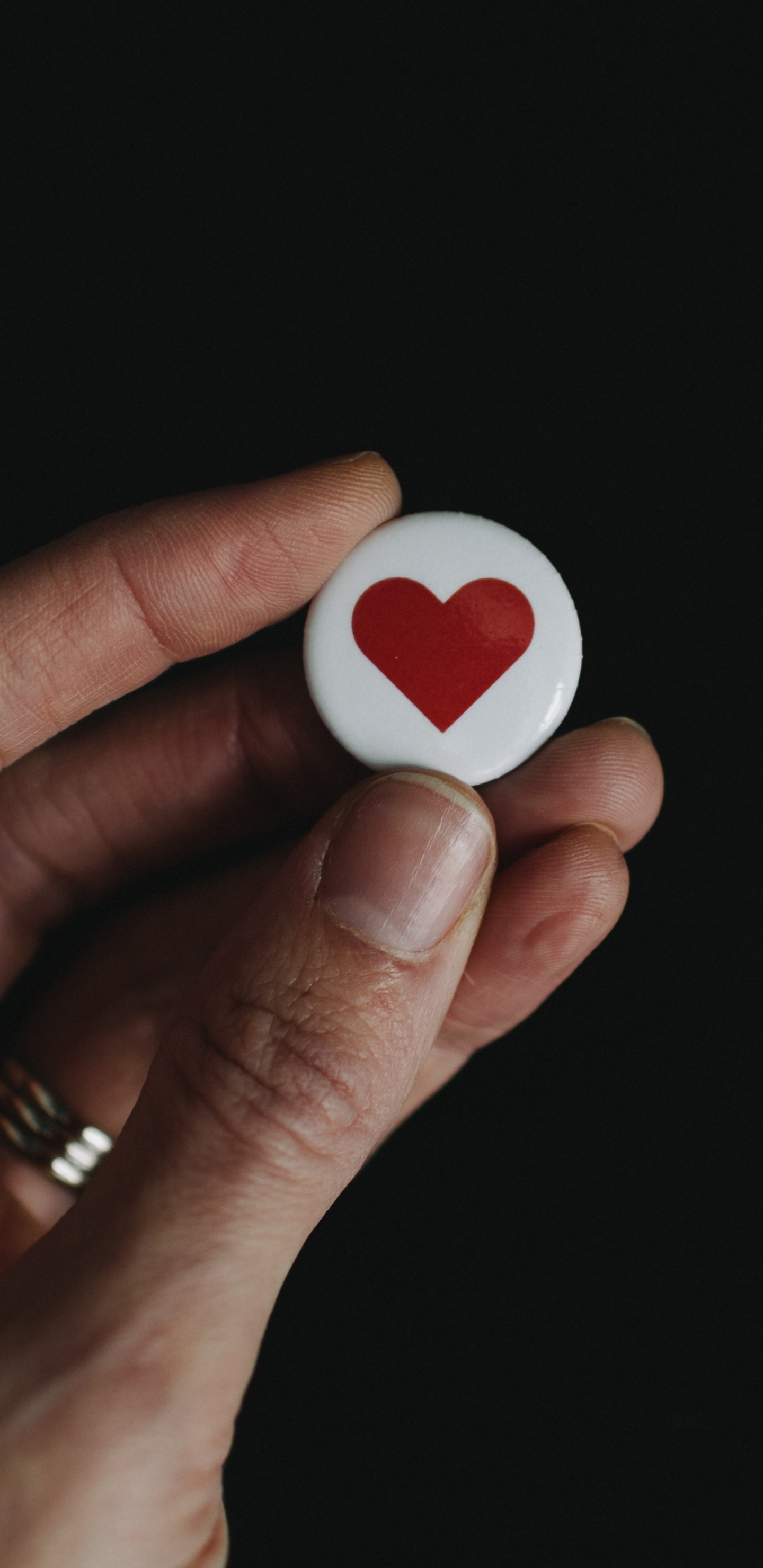 Person Holding White and Red Heart Shape Ornament. Wallpaper in 1440x2960 Resolution