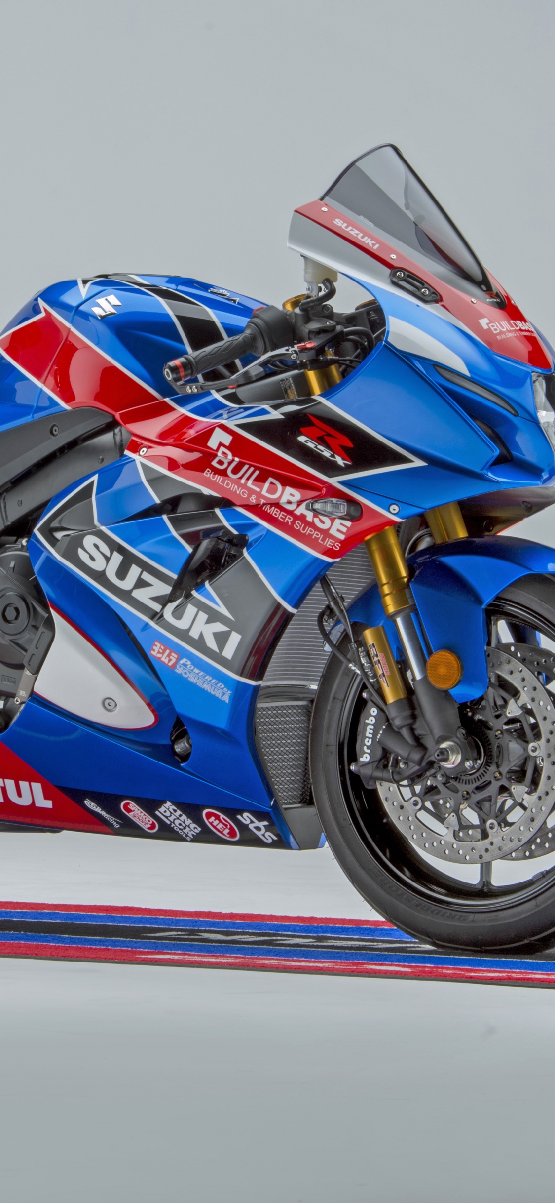 Blue and Red Sports Bike. Wallpaper in 1125x2436 Resolution