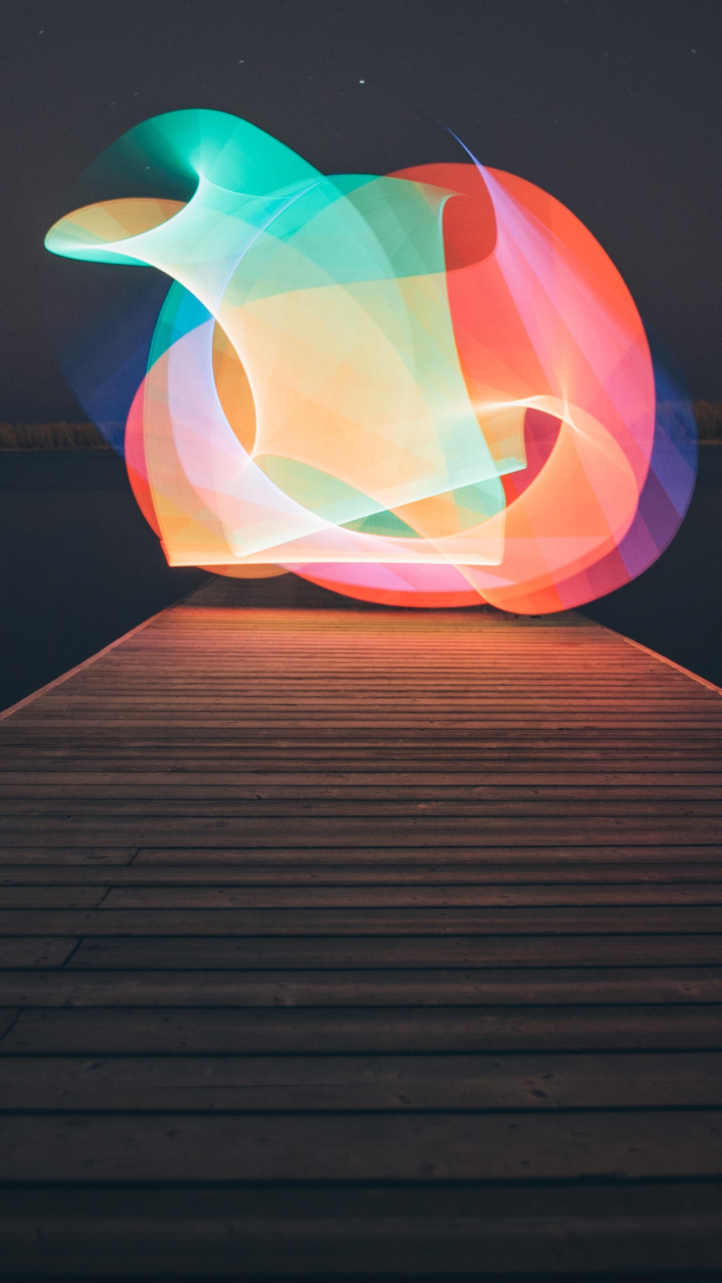 Pink and Yellow Inflatable Balloon on Brown Wooden Dock During Night Time. Wallpaper in 1440x2560 Resolution