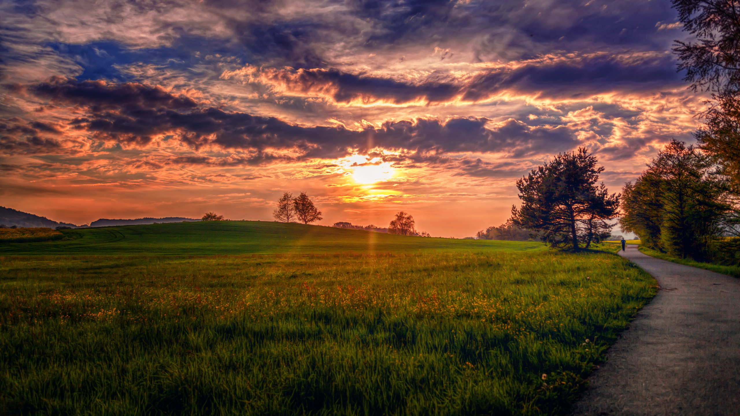 Green Grass Field Under Cloudy Sky During Sunset. Wallpaper in 2560x1440 Resolution