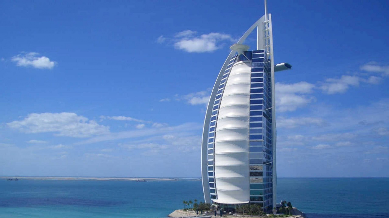 White and Blue Building Near Body of Water During Daytime. Wallpaper in 1366x768 Resolution