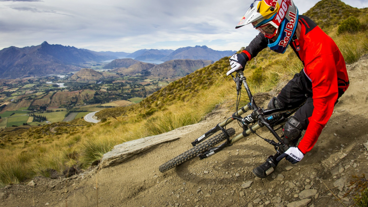 Man in Black Jacket Riding Black Mountain Bike on Road During Daytime. Wallpaper in 1280x720 Resolution