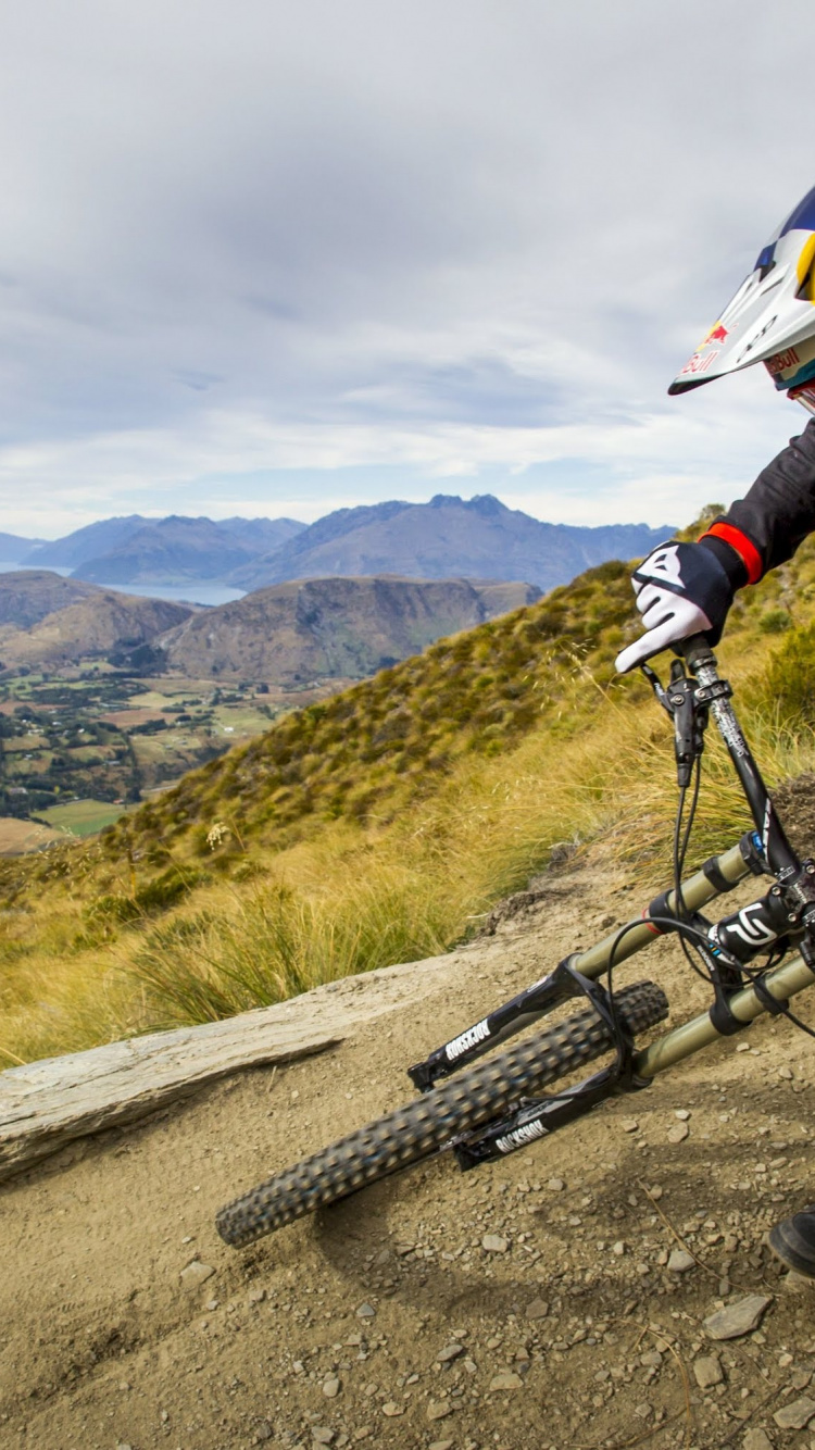 Man in Black Jacket Riding Black Mountain Bike on Road During Daytime. Wallpaper in 750x1334 Resolution