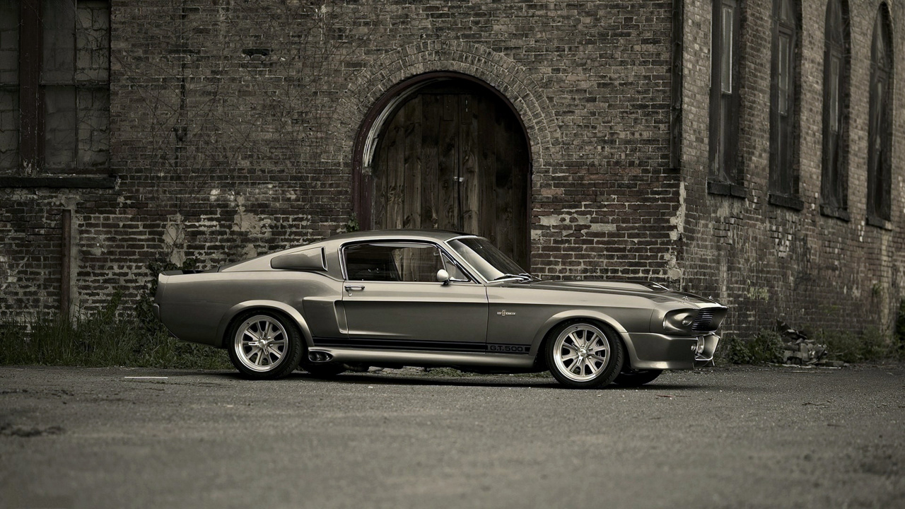 Grayscale Photo of Coupe Parked Beside Brick Wall. Wallpaper in 1280x720 Resolution