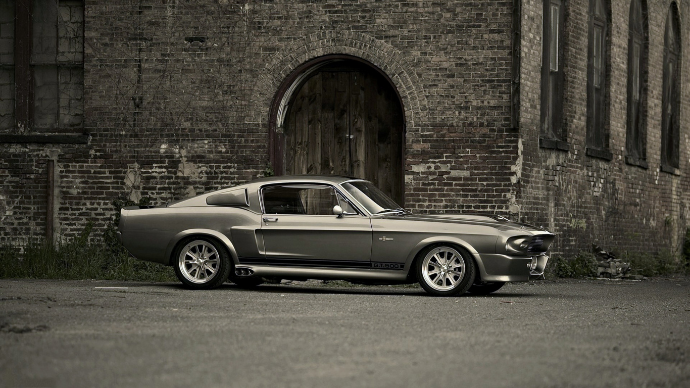 Grayscale Photo of Coupe Parked Beside Brick Wall. Wallpaper in 1366x768 Resolution